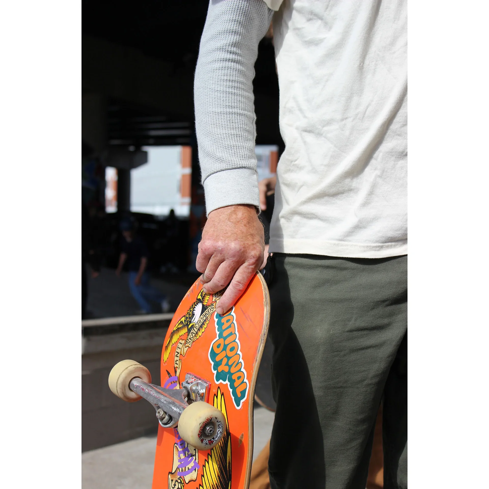 National DIY sticker logo on nose of skateboard.